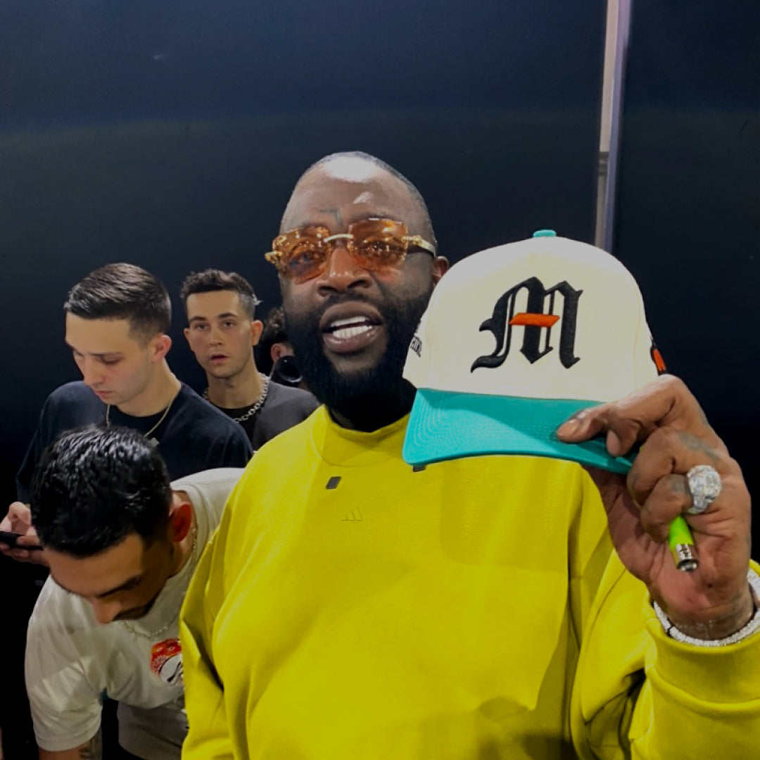 Rick Ross repping Miami Clothing Co. hat in teal at the Miami Got Sole event, showcasing bold style and Miami-inspired fashion.
